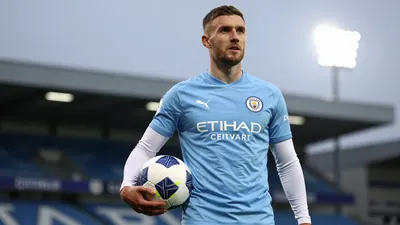 A photorealistic image of a Swansea City player in a blue shirt with white sleeves, holding a football, against a blurred...