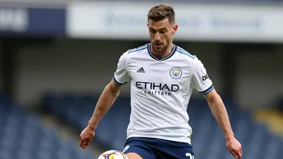 A photorealistic image of an anonymous Swansea City player, aged 25-30, in a 29-year-old Scotland centre-half's kit, with...