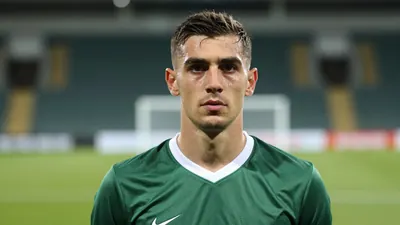 Mid-30s slender Swansea midfielder, intense gaze, head-and-shoulders, dark green shirt with white trim, plain cotton...