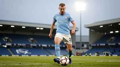A photograph of Swansea City forward Liam Cullen in action during a match, with the ball at his feet and a determined...