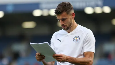 A mid-30s anonymous Swansea City midfielder, waist-up, wearing a solid white kit, looking thoughtful as he reviews a...