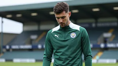 A concerned, dark-haired, 25-year-old Swansea City midfielder in a plain dark green and white training top, stands...